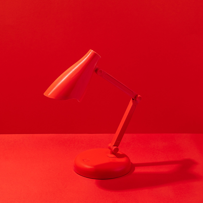 red table lamp on a red background, by Cavan Images / Aleksandr Kuzmin