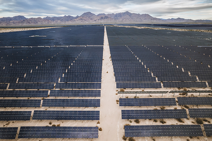 Rows of photovoltaic panels stretch for miles in Nevada, by Cavan Images / Chris Bennett