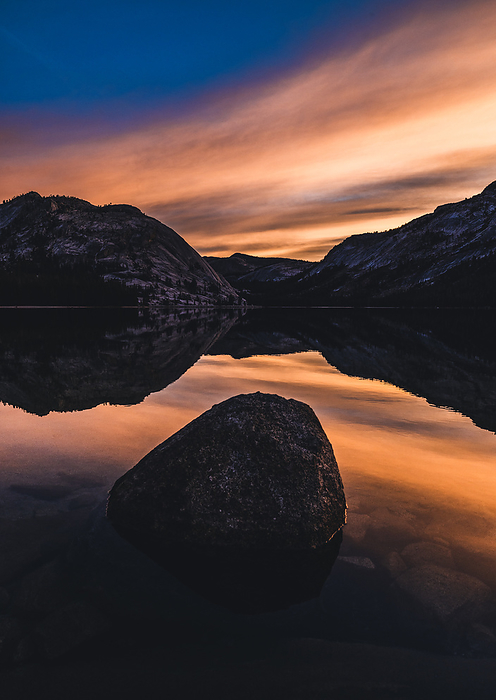 Sunrise over lake surrounded by mountains, Yosemite California, by Cavan Images / Chris Bennett