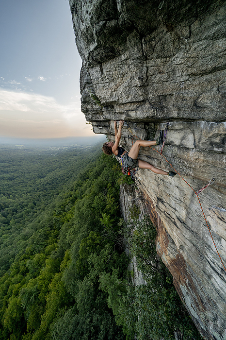 Rock Climbing Woman Leading at Sunset, by Cavan Images / Vultaggio Studios