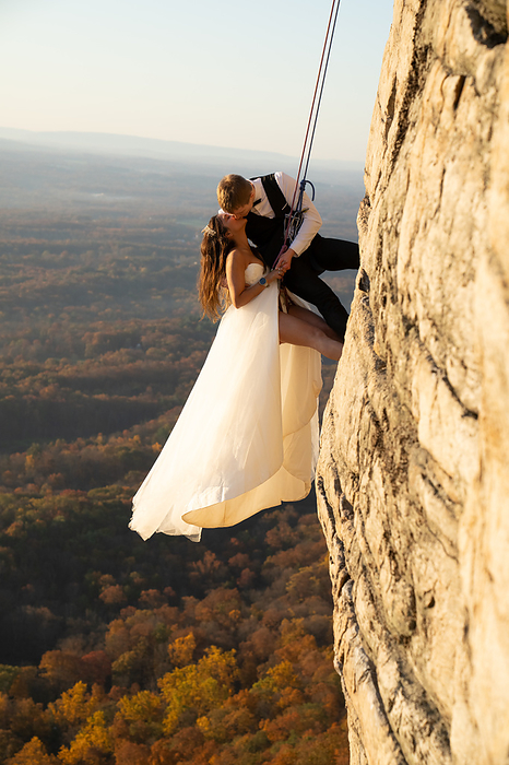 Rock Climbing Wedding Bride and Groom at Sunrise, by Cavan Images / Vultaggio Studios
