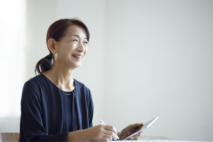 Japanese senior woman studying using a tablet device