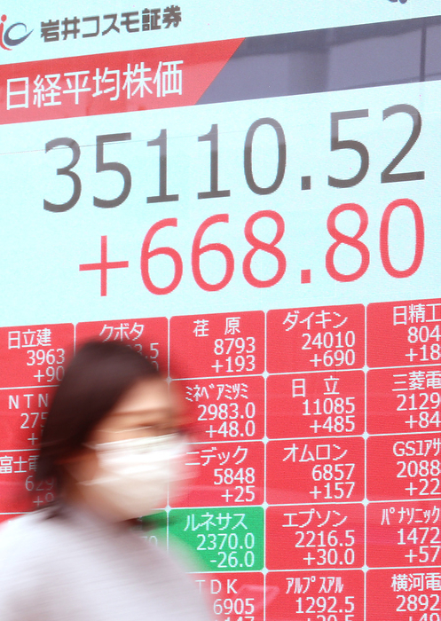 Nikkei 225 reached a post bubble high for consecutive days, temporarily exceeding 35,000 yen. January 11, 2024, Tokyo, Japan   A pedestrian pasees before a share prices board in Tokyo on Thursday, January 11, 2024. Japan s share prices rose 668.23 yen to close at 35,109.95 yen at the morning session of the Tokyo Stock Exchange.     photo by Yoshio Tsunoda AFLO 