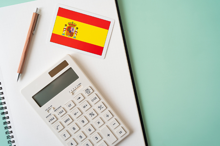 Spanish flag, calculator, notebook, pen
