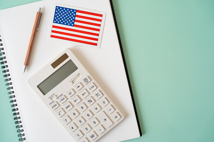 American flag, calculator, notebook, pen