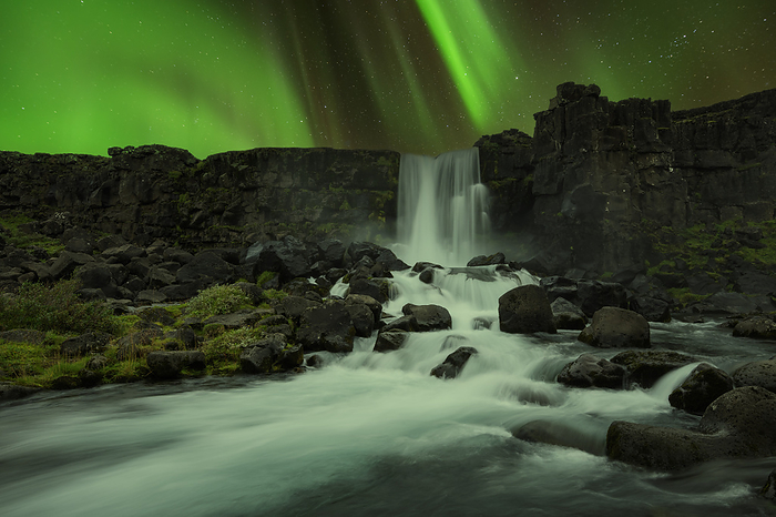 Iceland, Sudurland, Aurora Borealis over Oxararfoss waterfall at night