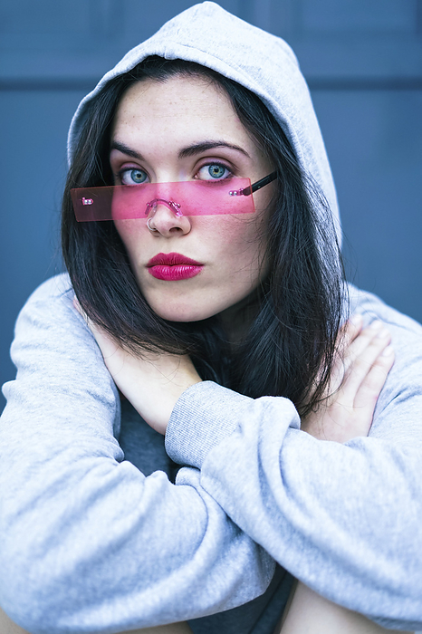 Woman wearing hooded shirt and smart glasses