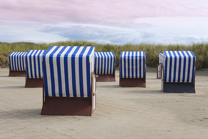 Germany, Lower Saxony, Hooded beach chairs on paved promenade on Norderney island