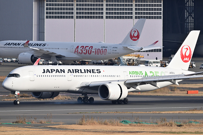 JAL s first Airbus A350 1000 with red logo on the rear of the fuselage at Haneda Airport JAL s third Airbus A350 900  reg. JA03XJ, foreground  with green logo landing at Haneda Airport and JAL s first Airbus A350 1000  JA01WJ  with red logo on the rear of the fuselage, on December 27, 2023. PHOTO: Tadayuki YOSHIKAWA Aviation Wire