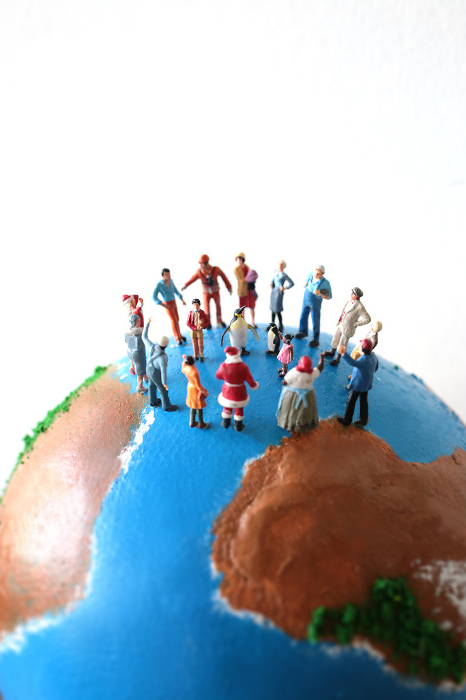 Globe and miniature dolls with the image of the earth with people from all over the world.