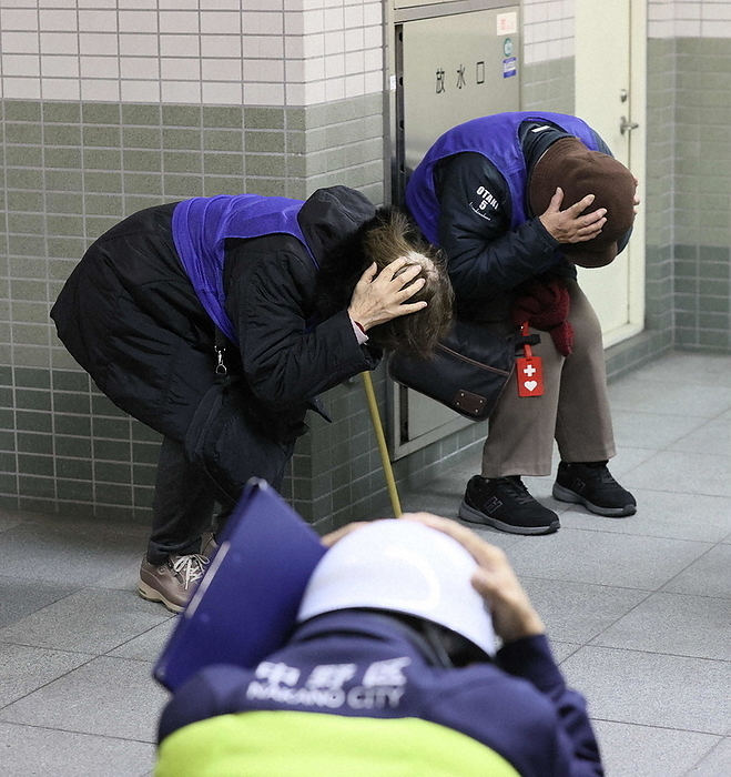 Ballistic missile scenario training in Tokyo Participants take shelter and crouch inside Higashi Nakano Station of the Tokyo Metropolitan Subway at 1:39 p.m. on January 15, 2024 in Nakano Ward, Tokyo, during a joint national protection drill based on the assumption that a ballistic missile has been launched.
