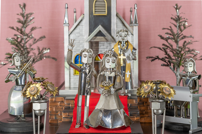 Happy couples get married in church, metal figurine