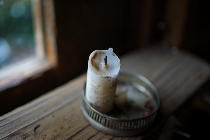 A vanished candle in the window of an old house