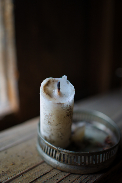 A vanished candle in the window of an old house