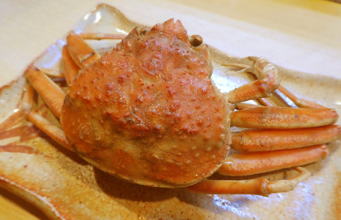 The rich flavor of the inner eggs and crabmeat is a taste only winter can offer. Photo of boiled female snow crab in salt water