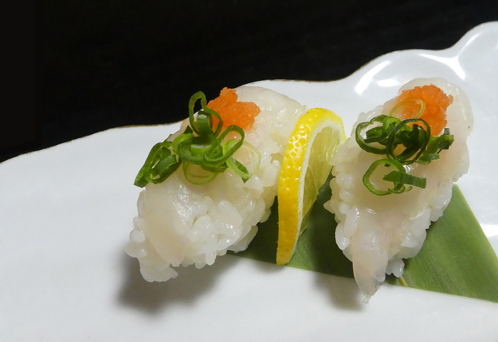 Taste the crunchy flavor in nigiri-zushi, a picture of fugu sashimi.