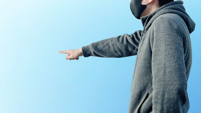 Masked Man Pointing Lateral View_Blue Sky Background Wide
