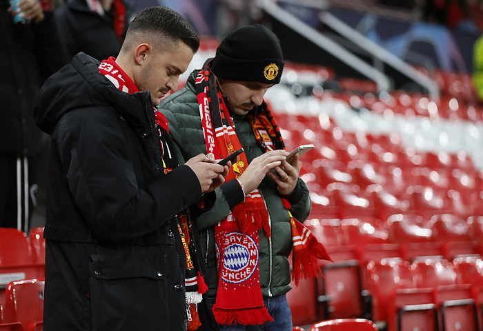 Manchester United v FC Bayern M nchen: Group A   UEFA Champions League 2023 24 Manchester United fans checking mobile phones before the UEFA Champions League match between Manchester United and FC Bayern Munchen at Old Trafford on December 12, 2023 in Manchester, England.   WARNING  This Photograph May Only Be Used For Newspaper And Or Magazine Editorial Purposes. May Not Be Used For Publications Involving 1 player, 1 Club Or 1 Competition Without Written Authorisation From Football DataCo Ltd. For Any Queries, Please Contact Football DataCo Ltd on  44  0  207 864 9121