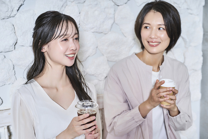 Japanese women conversing over coffee (People)