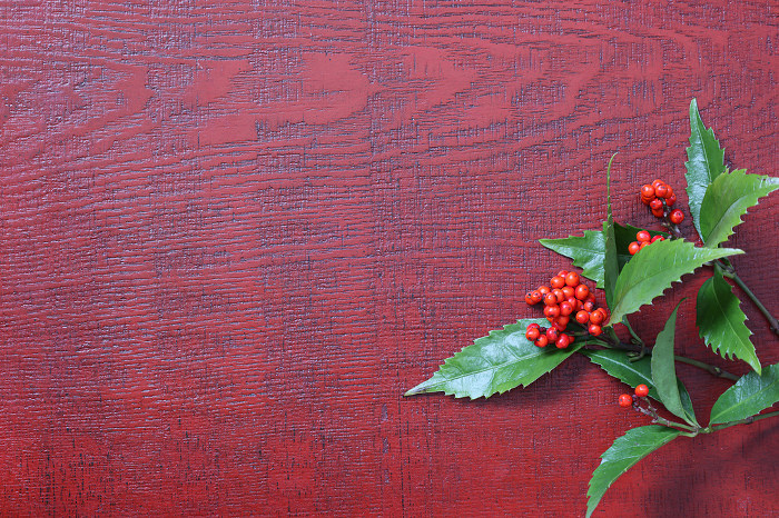 Red berries and leaves placed on lacquered board