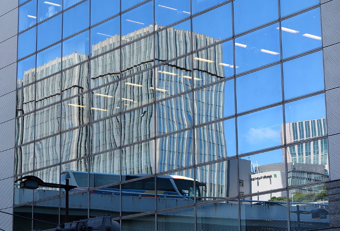 All-glass building wall, distorted reflection due to wind pressure from strong winds