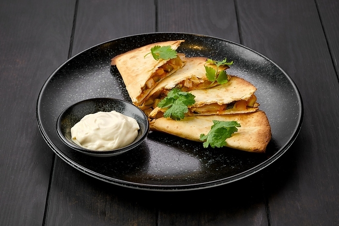 Quesadilla with chicken meat, cheese and pickled cucumber with mayonnaise sauce
