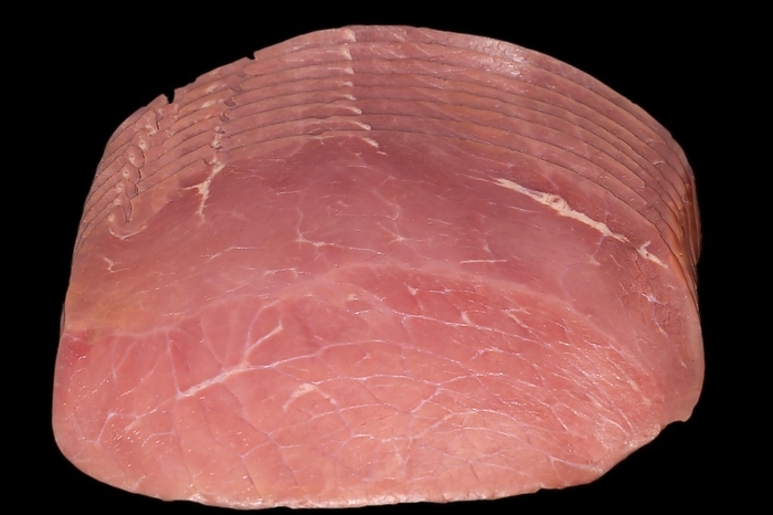 Several slices of cured beef ham, studio photography with black background