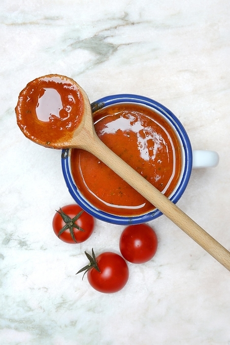 Cup with tomato soup and cooking spoon, Germany, Europe