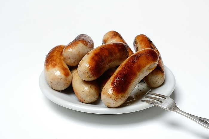 Chipolata sausages on plate, roasted, Switzerland, Europe