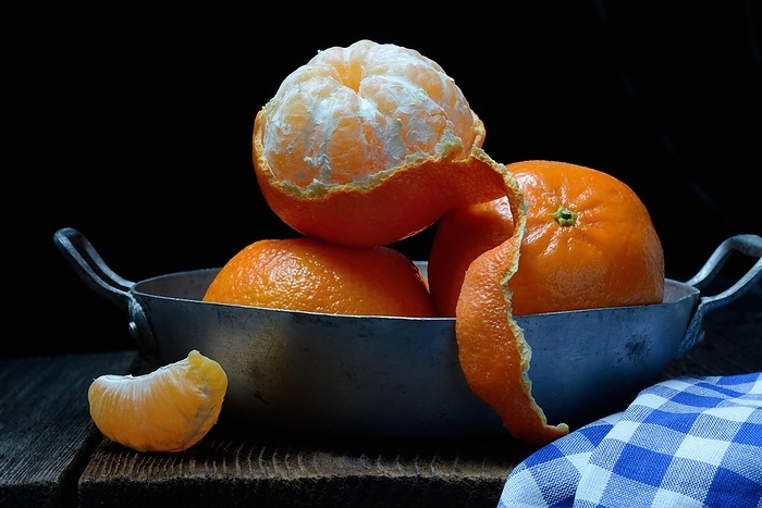 Clementines in a pan, unpeeled and half-peeled, Germany, Europe
