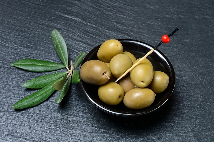Greek olives from Chalkidiki in small bowls, olive branch, Germany, Europe