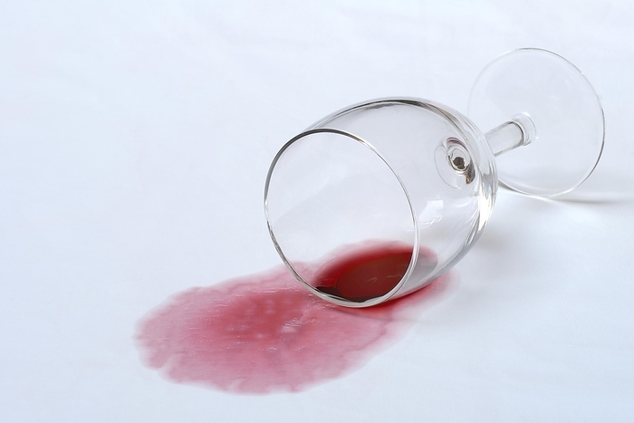 Red wine stain, overturned red wine glass on fabric, stain