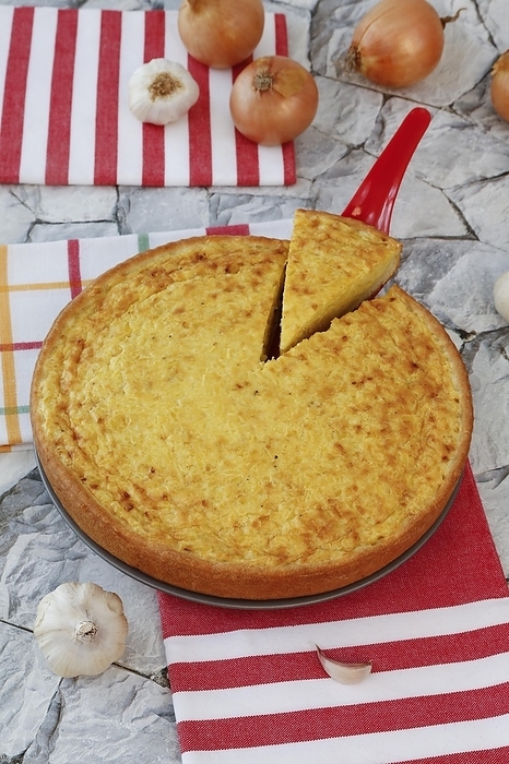 Swabian cuisine, Härtsfeld potato cake with curd dough base, savoury cake, bake, out of the oven, hearty, vegetarian, healthy, cake scoop, cake server, onions and garlic in the back, typical Swabian, traditional cuisine, food photography, studio, Germany, Europe