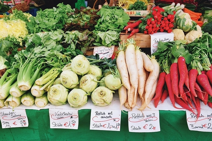 Freiburg, Germany, April 2022: Vegetables like celery, radish or lettuce at market sale booth, Europe