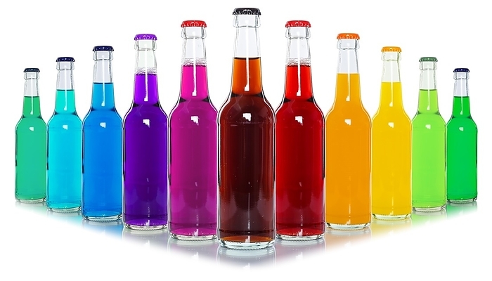 Bottles with colourful drinks, in a row, free-standing