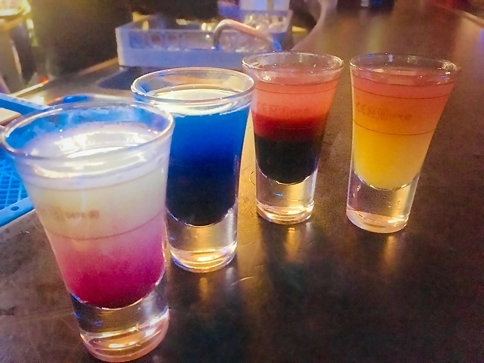 Colorful drinks, shots at a bar, colorful alcohol