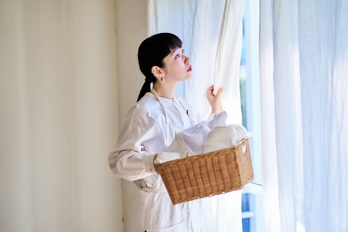 Young Japanese woman with laundry (People)