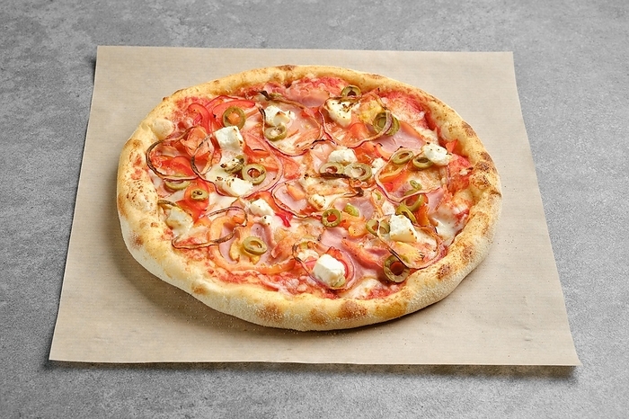 Top view of pizza with ham, onion and feta cheese on parchment paper, by Aleksei Isachenko