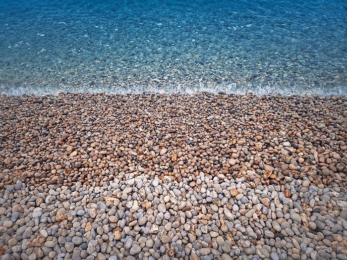 Pebble rocks beach and blue sea water texture, by PsychoShadow