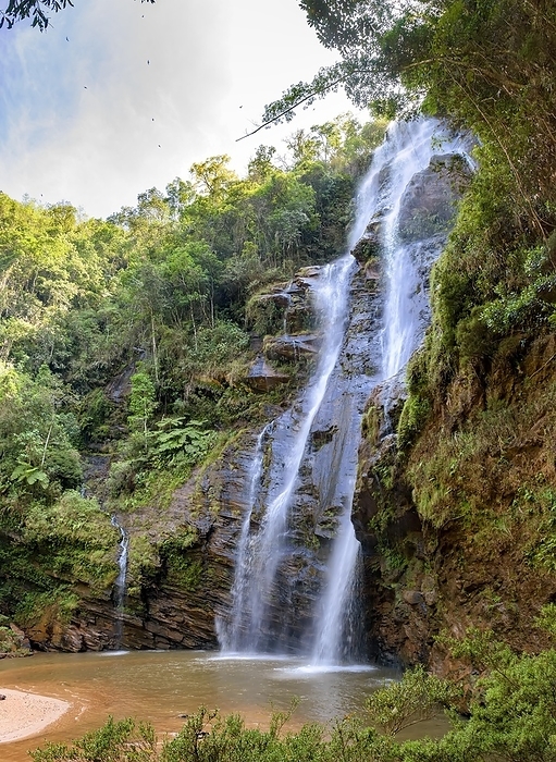 Stunning waterfall among the dense vegetation and rocks of the rainforest in the state of Minas Gerais, Brazil, South America, by Fred Pinheiro