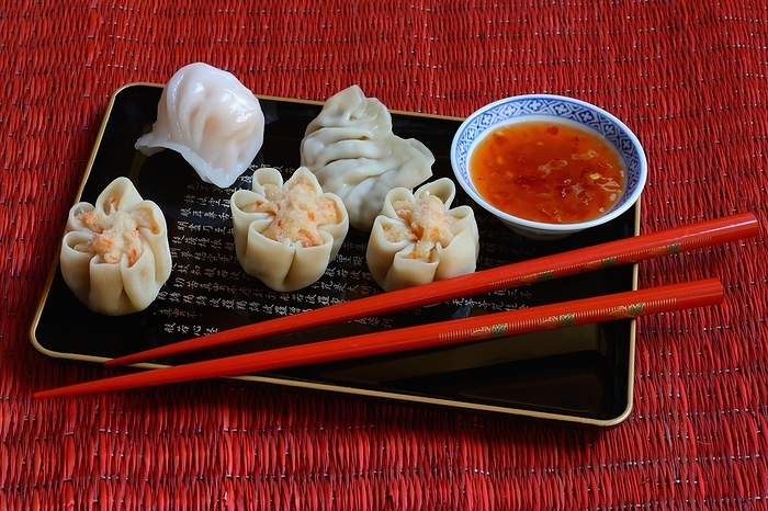 Dim Sum, filled dumplings on tray with red chopsticks and chilli sauce, Germany, Europe, by Jürgen Pfeiffer