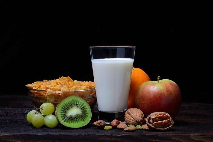 A glass of milk, bowl with cornflakes, fruits and nuts, Germany, Europe, by Jürgen Pfeiffer