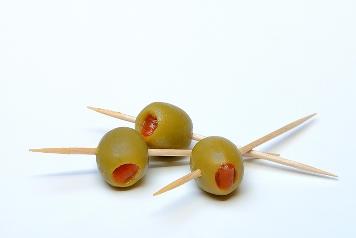 Green olives on toothpicks, stuffed with pieces of paprika, by Jürgen Pfeiffer