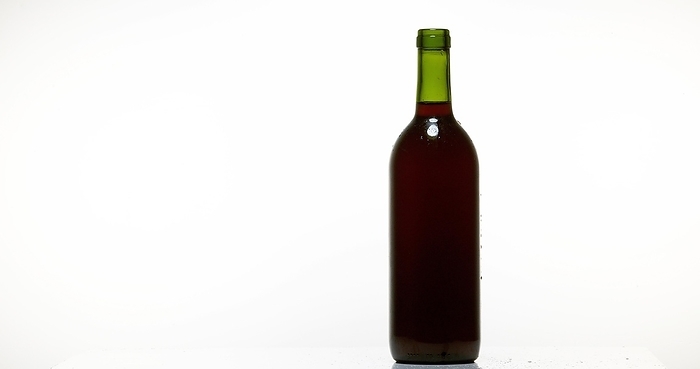 Bottle of Red Wine against White Background, by Lacz Gerard