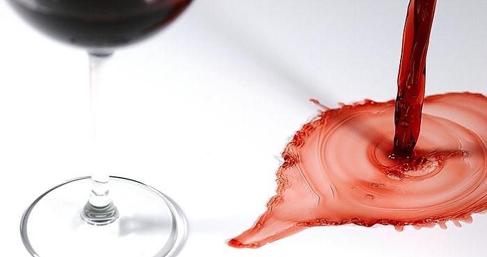 Red Wine being poured into Glass, against White Background, by Lacz Gerard