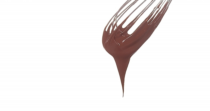 Chocolate Flowing from Whisk on White Background, by Lacz Gerard