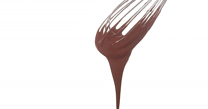 Chocolate Flowing from Whisk on White Background, by Lacz Gerard