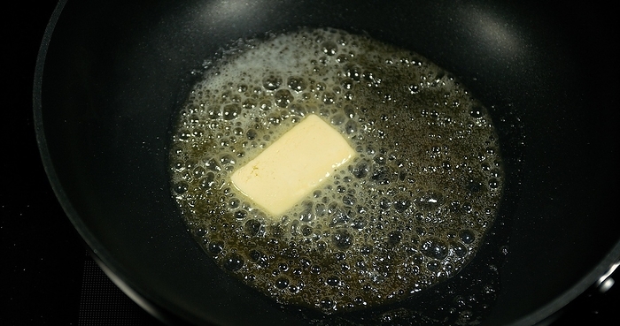 Butter that melts and crackles in a stove, by Lacz Gerard