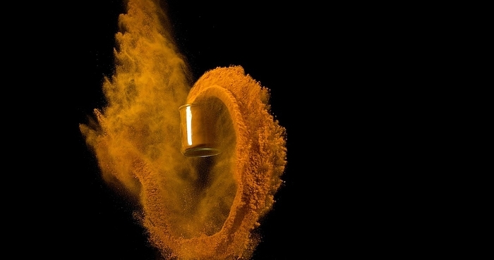 Turmeric (curcuma longa), Powder in a Small Jar falling against Black Background, Indian Spice, by Lacz Gerard