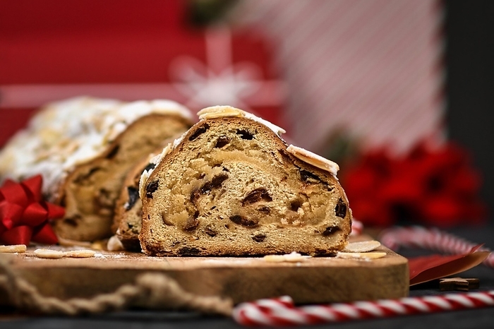 Slice of German Stollen cake, a fruit bread with nuts, spices, and dried fruits with powdered sugar traditionally served during Christmas time, by Firn